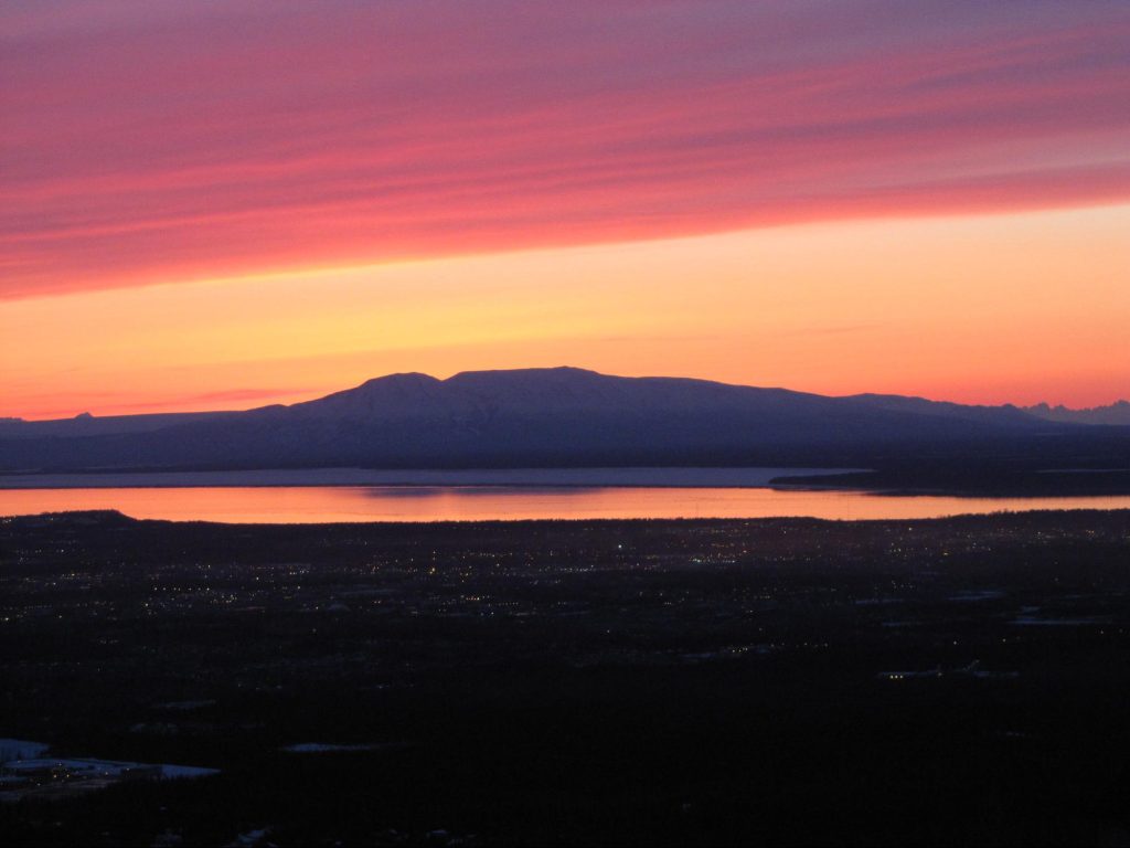 A colorful sunset over Mount Sustina, AKA Sleeping Lady, in Alaska.
